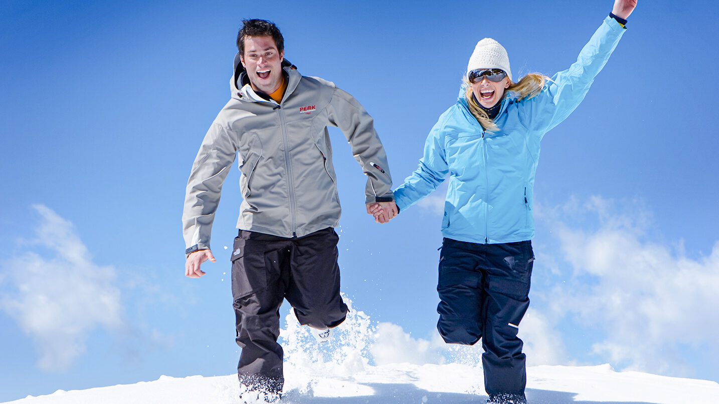 glückliches Paar im Schnee laufen